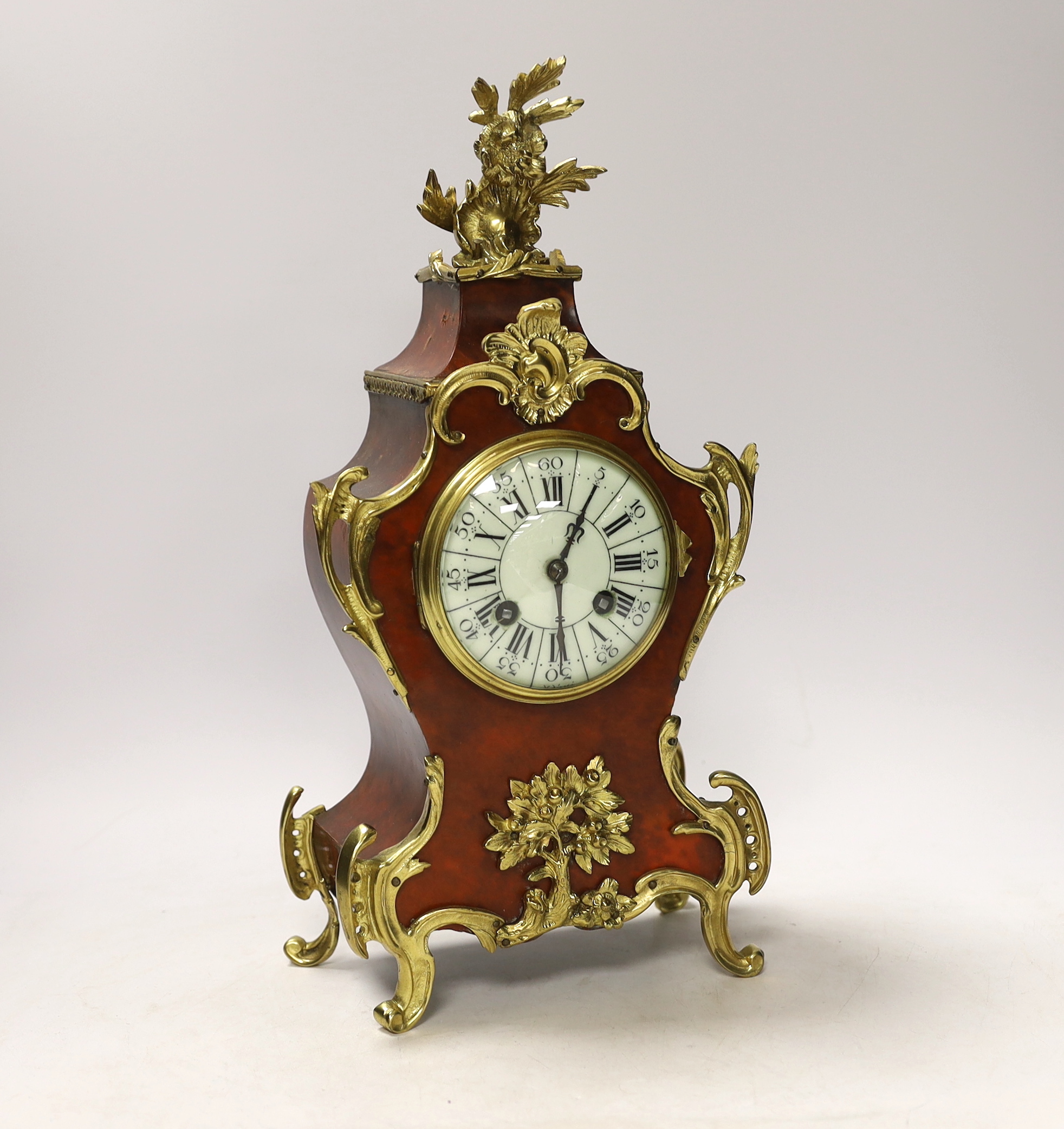 A Louis XV style tortoiseshell and ormolu mounted mantel clock with enamel Roman numeral dial, 35cm high